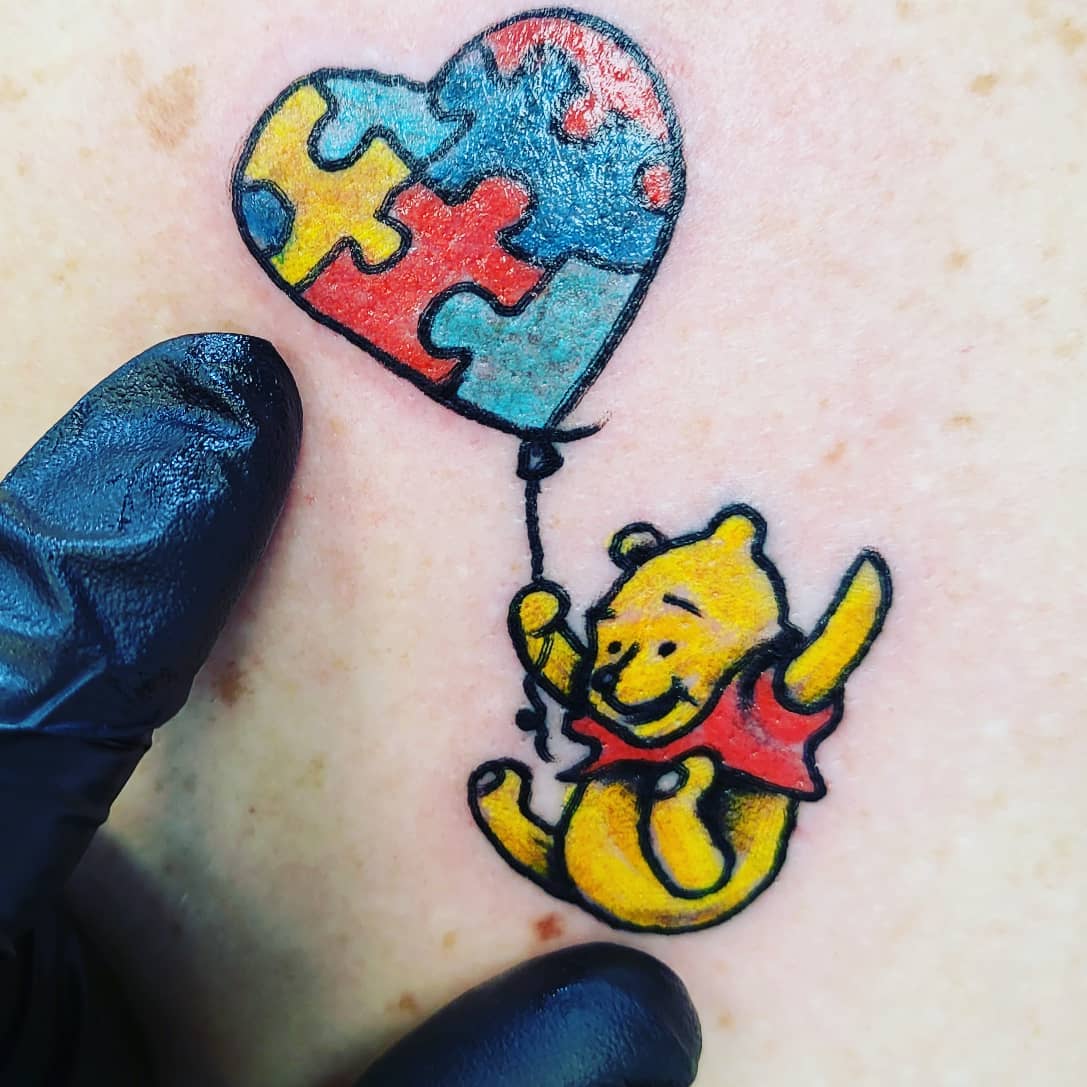 This Winnie Pooh tattoo is fun and retro. If you enjoy cartoons and want to make the concept sentimental consider this design.