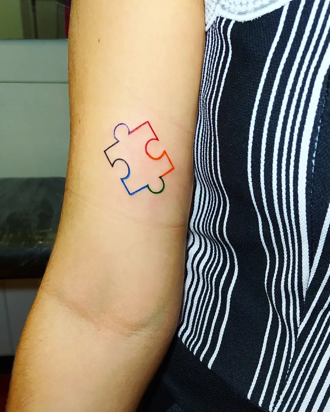 Men or women who are into minimalism will also enjoy this cute puzzle forearm tattoo.