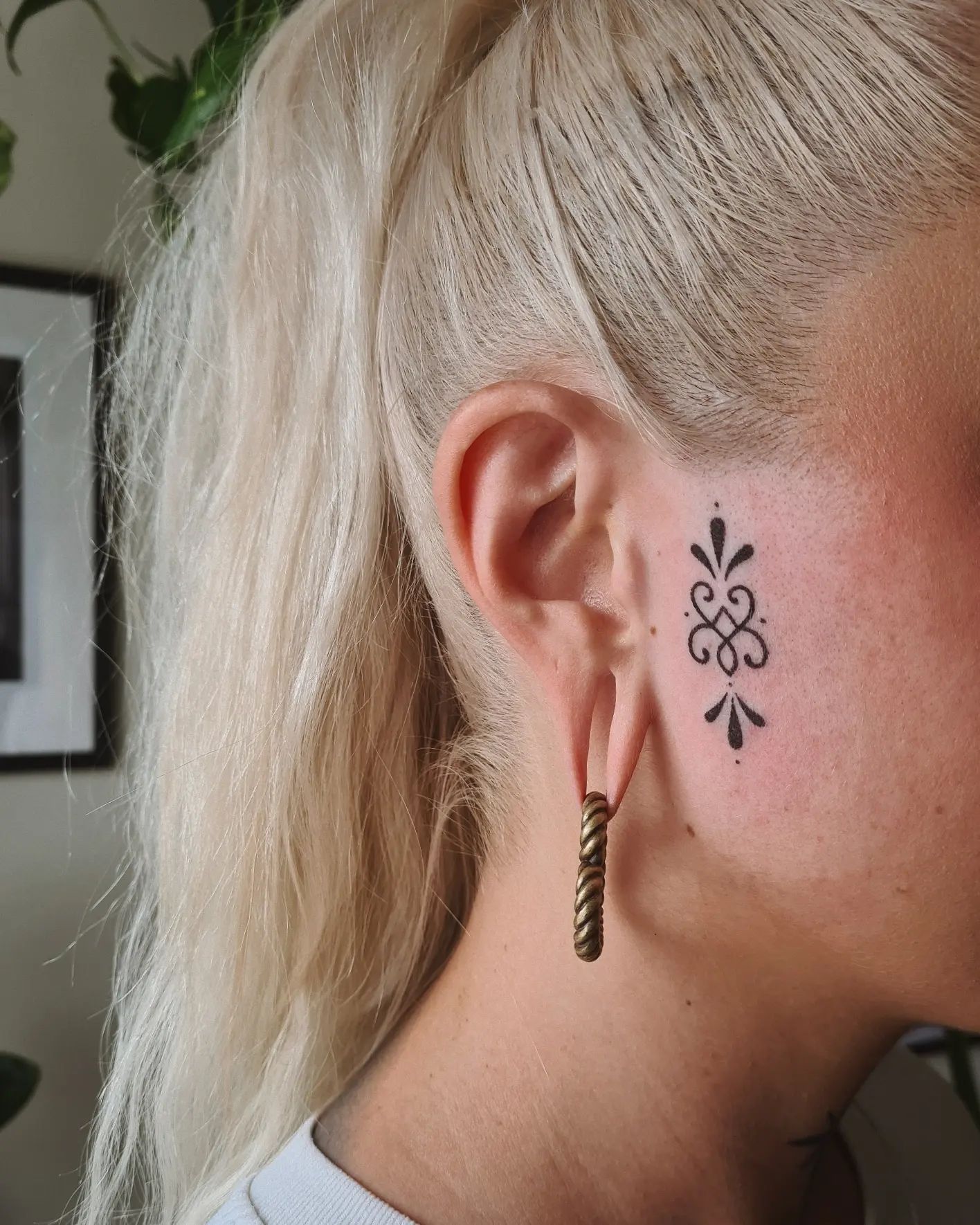 Show your love for sentimental and smaller pieces. Women who like to play with different mysterious symbols will also see the beauty of this face tattoo.