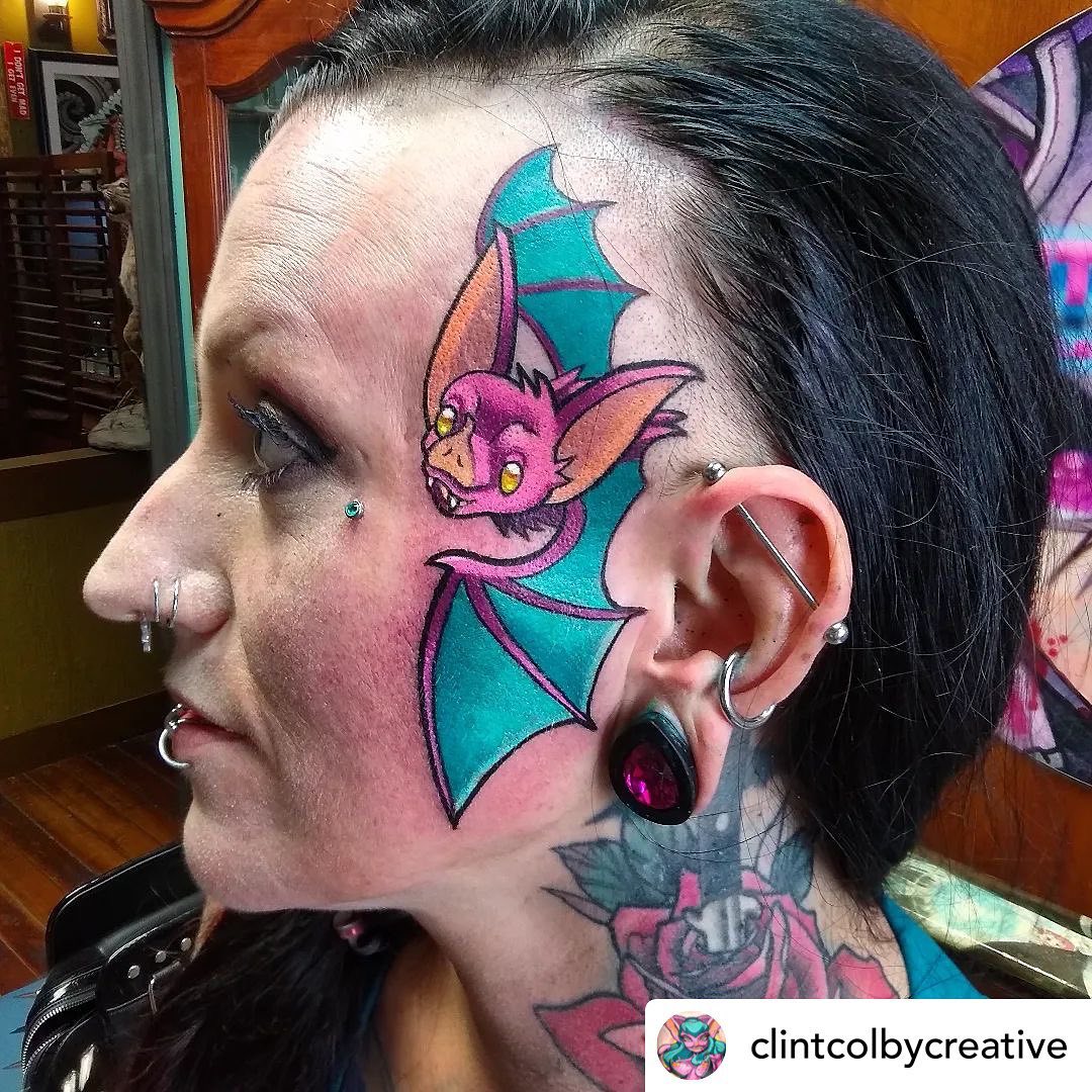 A cool bright neon bat such as this one is for those who like attention. Do you fancy larger tattoos? Have you ever thought about rocking a bold and bright neon print? Show how wild you are with this face tattoo.