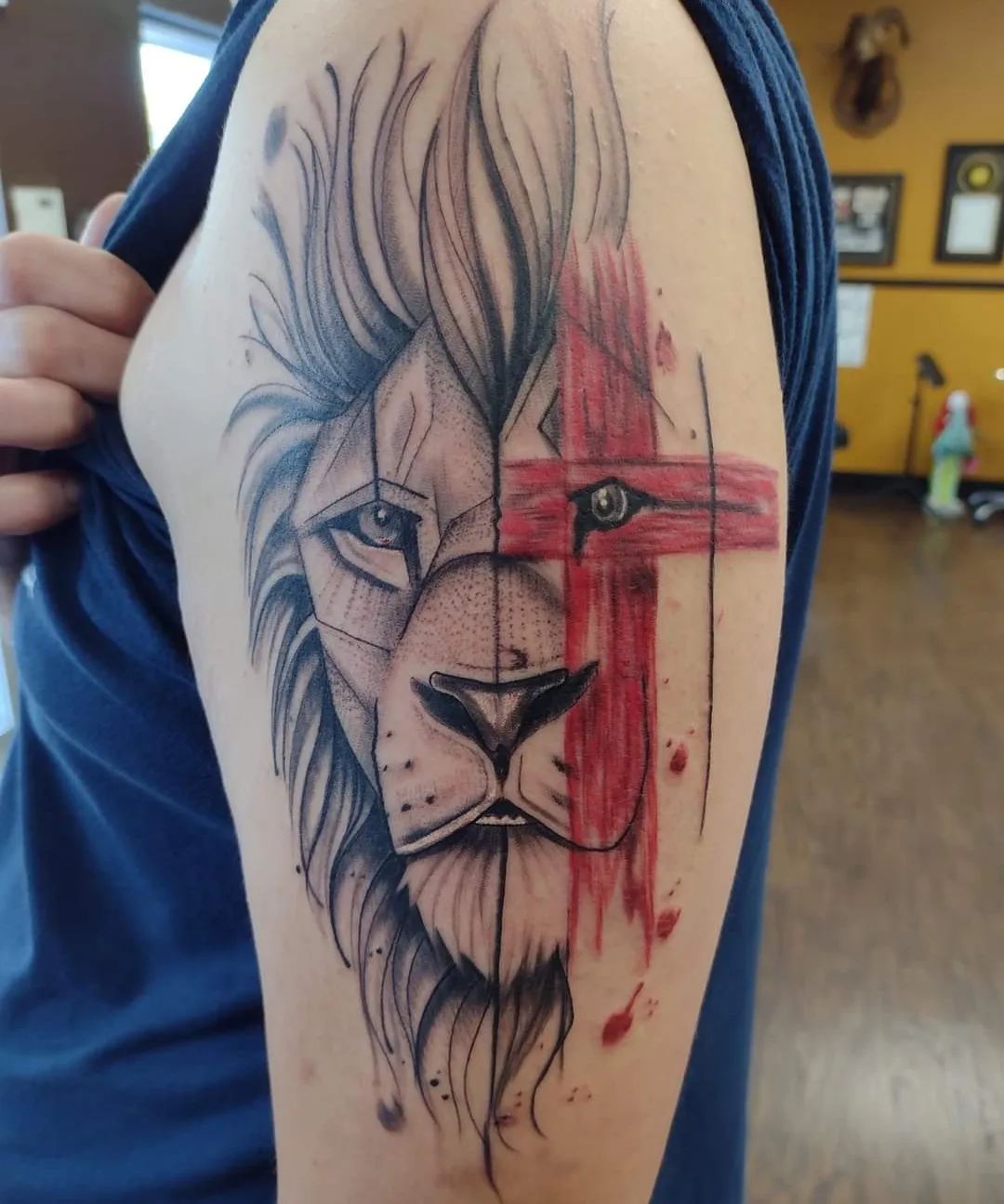 Throught the history, many cultures have featured lions in their texts and many artworks can be seen featuring lions. It's because these animals are a symbol of strength, courage and fearlessness. To combine a lion tattoo with a cross is a good idea for that since all these meanings above can be associated with Jesus. Red cross symbolizes the blood from his crucifixion.