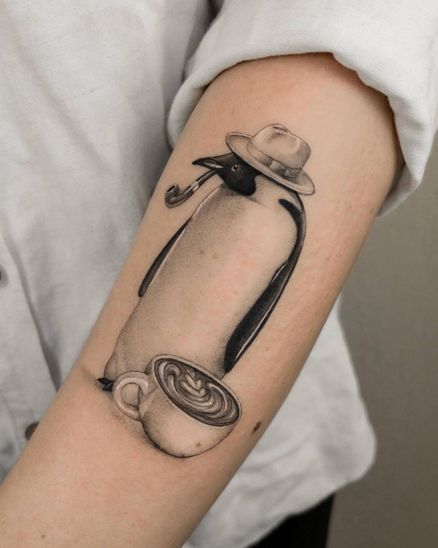 Are you addicted to coffee? Then, why not a penguin is addicted to it? Let's have fun with your penguin tattoo like the one above.