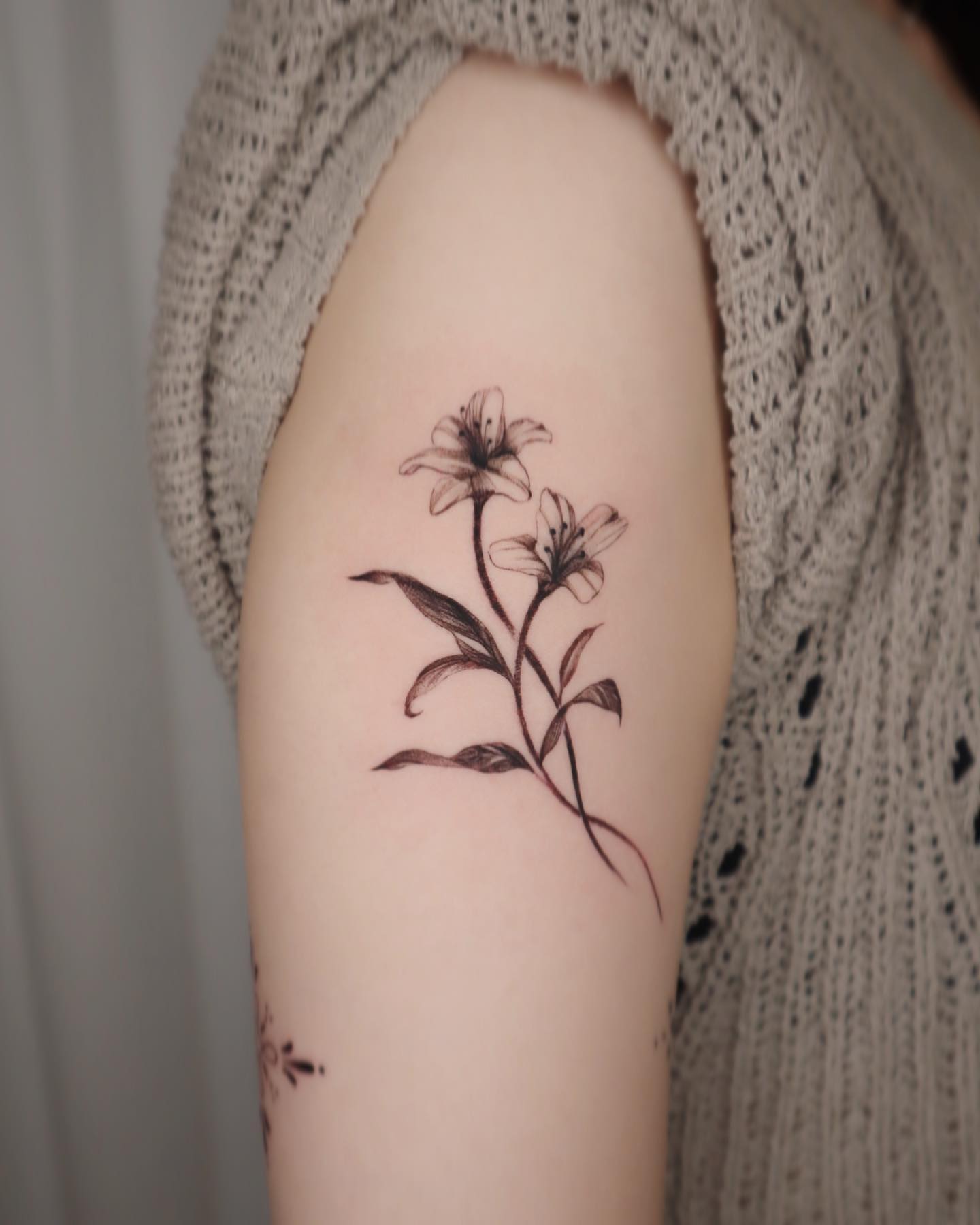 Two blackwork lilies tattoos are a simple, elegant design that can be done in a variety of ways. They're usually done in black ink, just like in the example below but you can also get them in other colors. Your arm will shine with them.