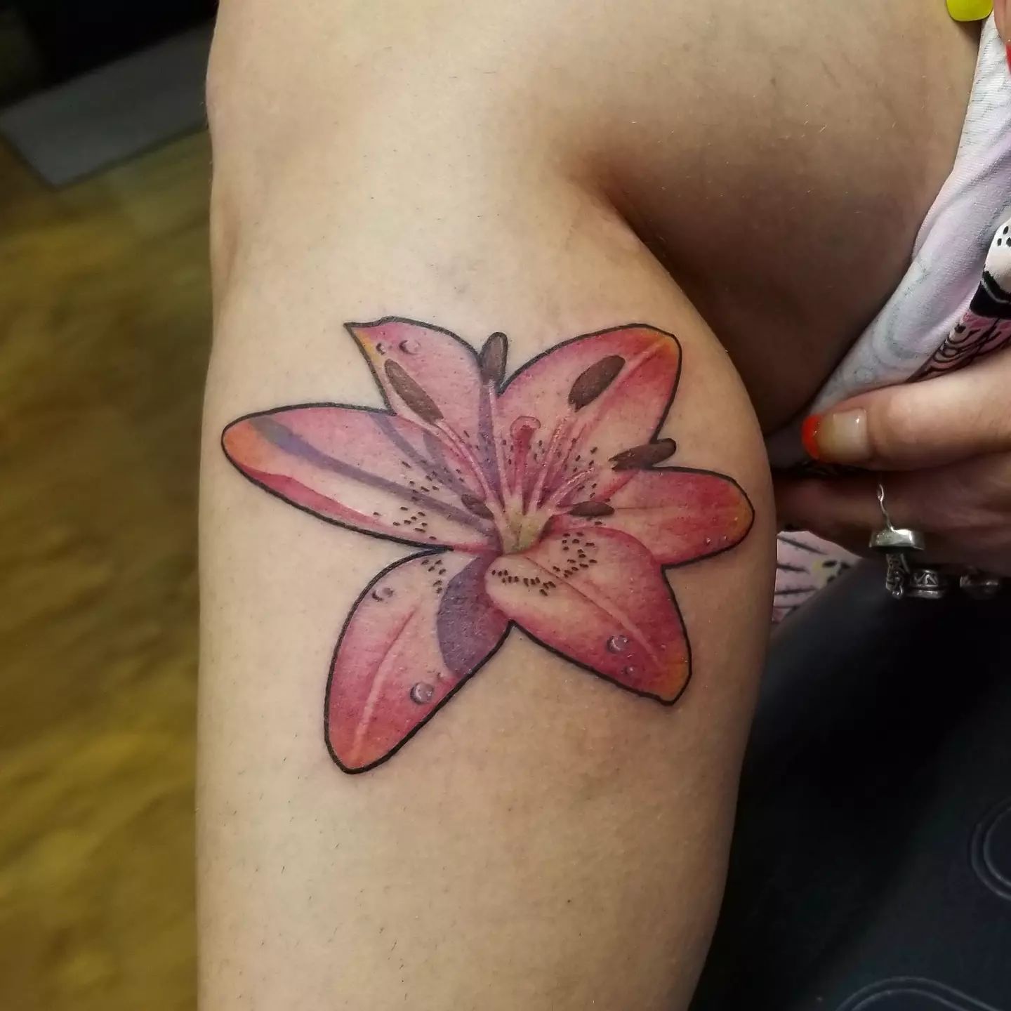 Lily tattoos are a great way to honor someone you love, or even yourself. If you are bold enough, you can get a bigger size of it on your lower leg just like in the example above. With all of its shading and color palette, this lily tattoo will make you shine.