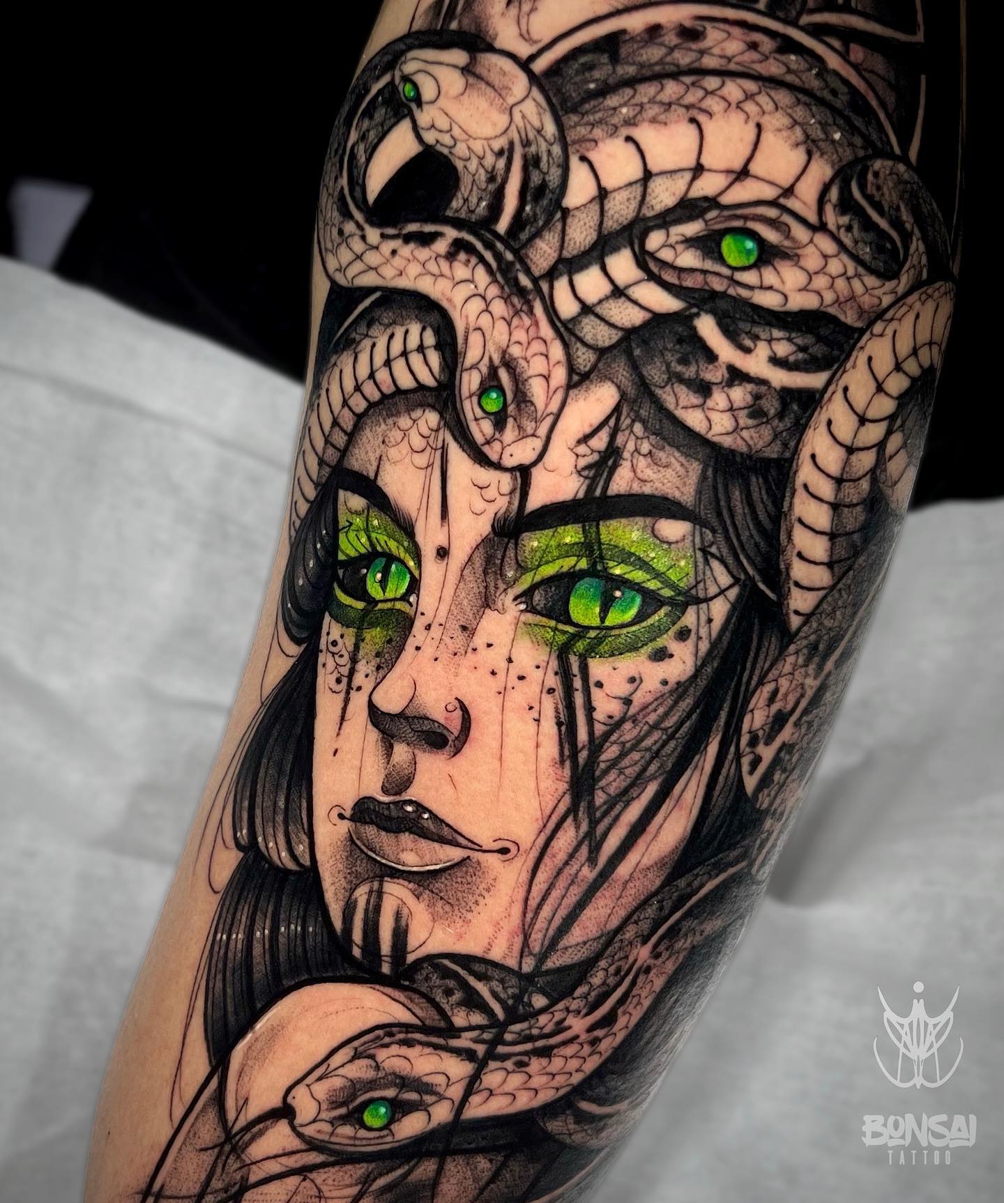 Do you know spiritual meaning of green eyes? Here it is: The green in the eyes symbolize enlightenment and connection to spirit. The snakes' and Medusa's eyes seems like they connect to each other spiritually. What are you waiting for to get this fabulous tattoo?