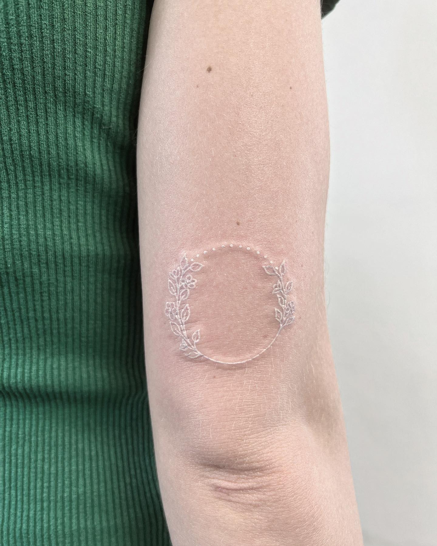 A circular tattoo is a great way to show your love for the earth and all its creatures since the shape represents the world in a way. Flowers surrounding it looks like they add an extra beauty to the tattoo!
